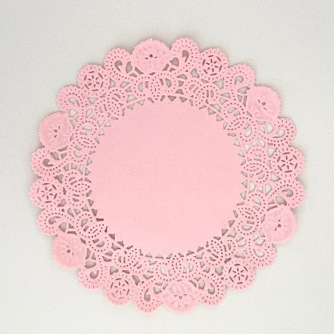 pink colored 5 inch round paper doilies
