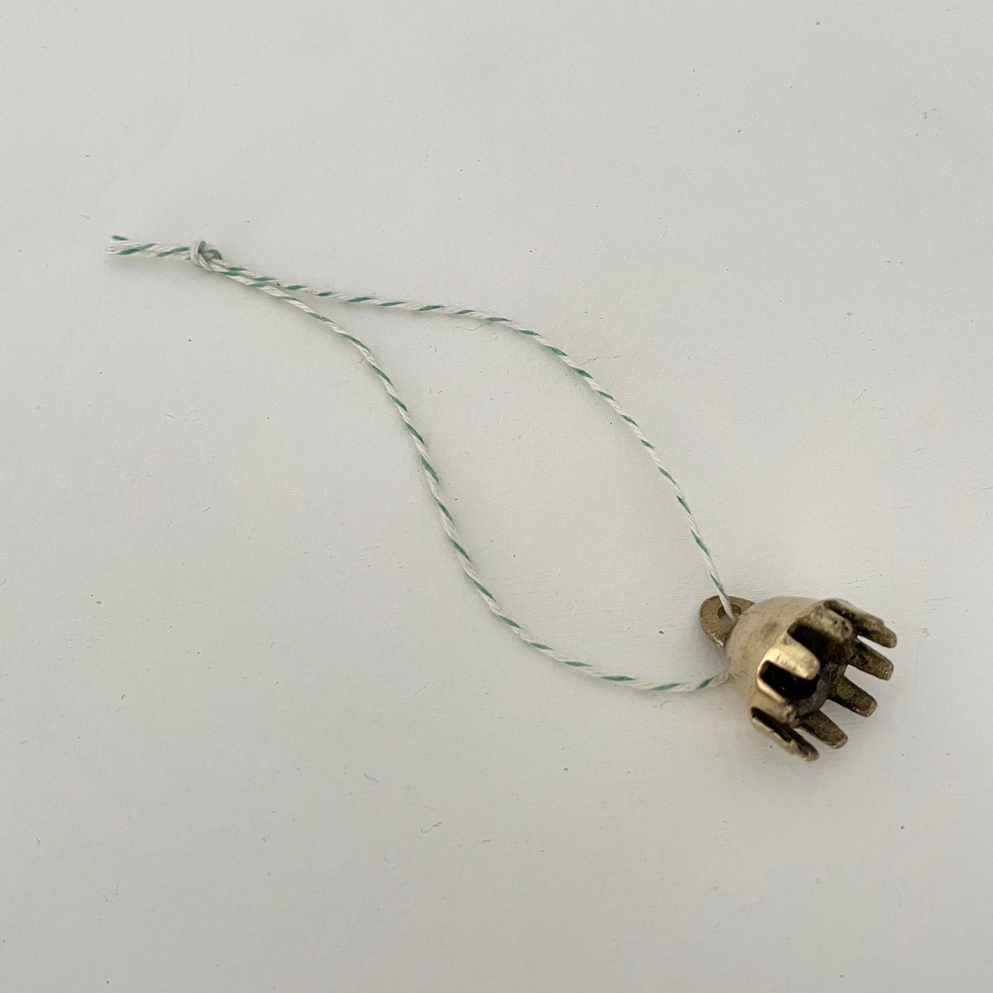 7/8" mini brass claw bell ornament on green and white striped bakers twine