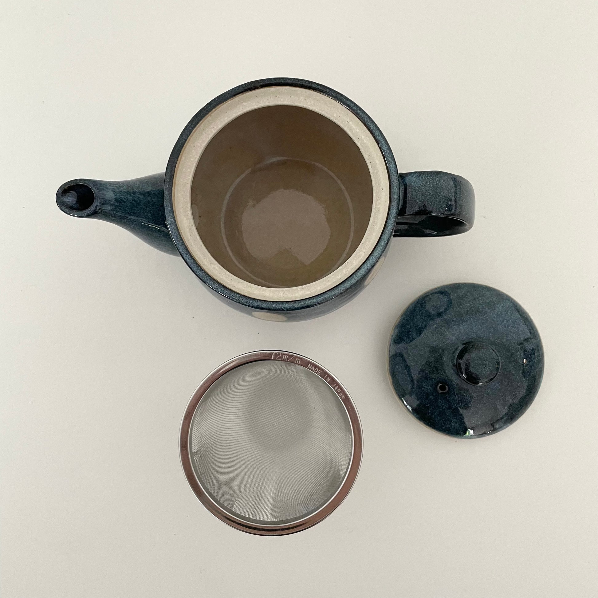 whimsical blue and white polka dot ceramic Japanese handmade teapot with metal strainer