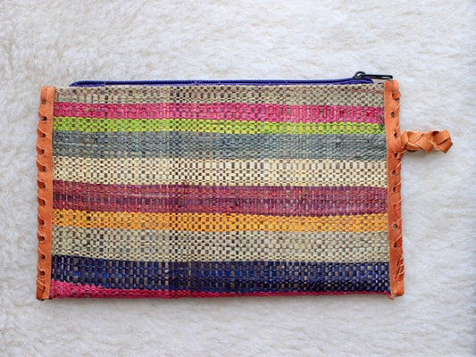 multi-colored muted striped raffia woven zippered clutch with leather trim bohemian