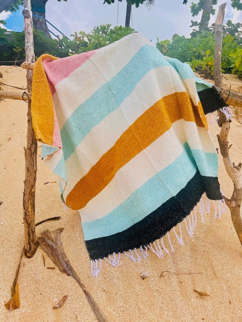 desert striped Mexican fringed throw blanket in hues of mustard, blush, turquoise, cream, and black