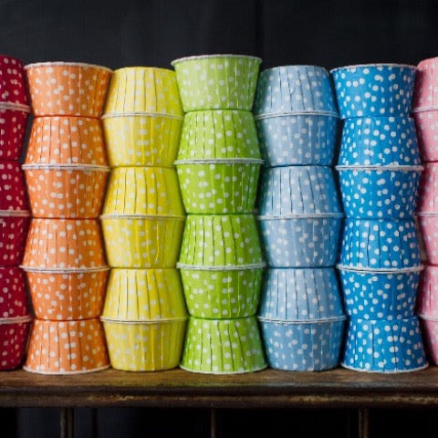 polka dot nut cups or cupcake liners in a rainbow of colors for a party