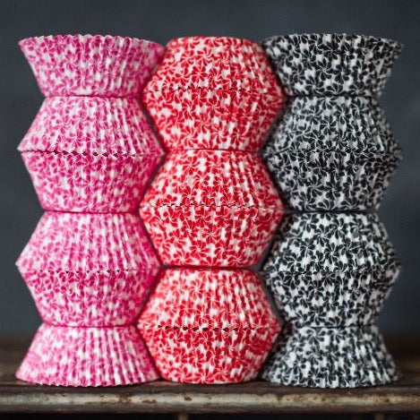 hot pink, red, black, and white pinwheel flower printed paper cupcake liners