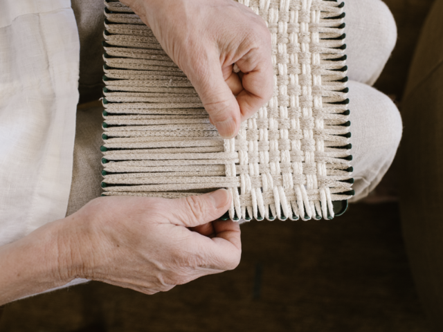 handmade 100 percent cotton geometric woven potholder or trivet on the loom for a farmhouse kitchen