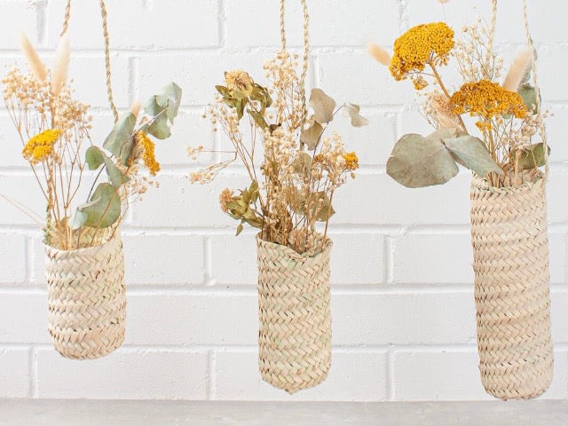 slim hanging sustainably harvested palm fiber woven hanging handmade moroccan baskets filed with dried flowers