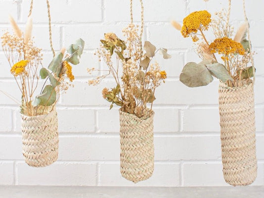 slim hanging sustainably harvested palm fiber woven hanging handmade moroccan baskets filed with dried flowers