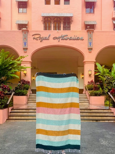 desert striped Mexican fringed throw blanket in hues of mustard, blush, turquoise, cream, and black