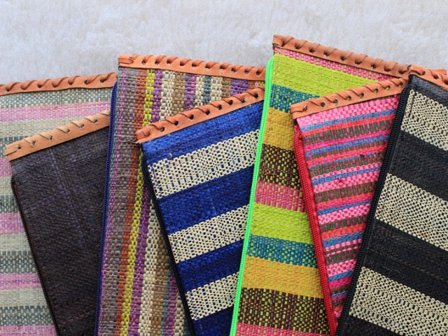 bohemian raffia woven zippered clutch with leather trim in an assortment of colors