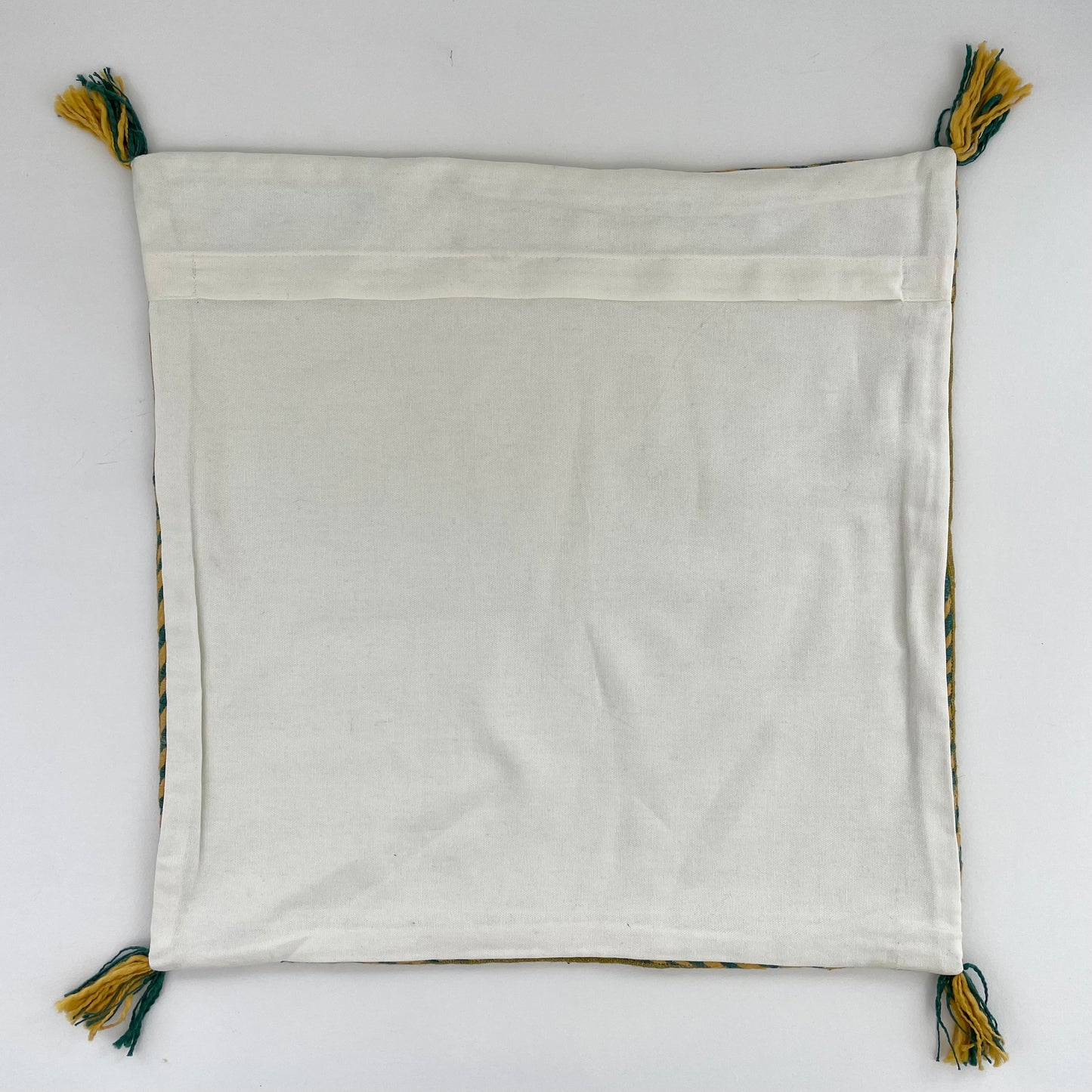 mustard yellow linen 18x18 square pillow cover with striped edging and tassels