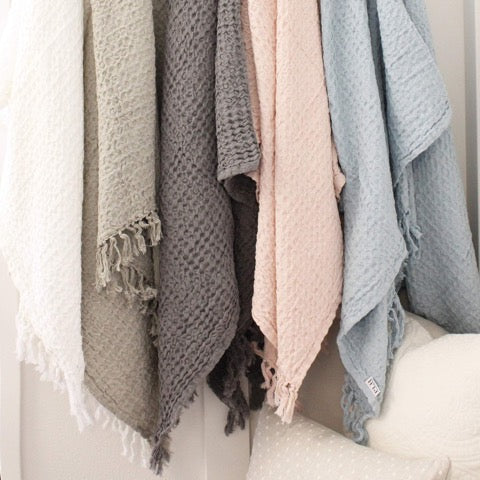 100 percent stone washed waffle fringed lightweight throw in muted neutral colors