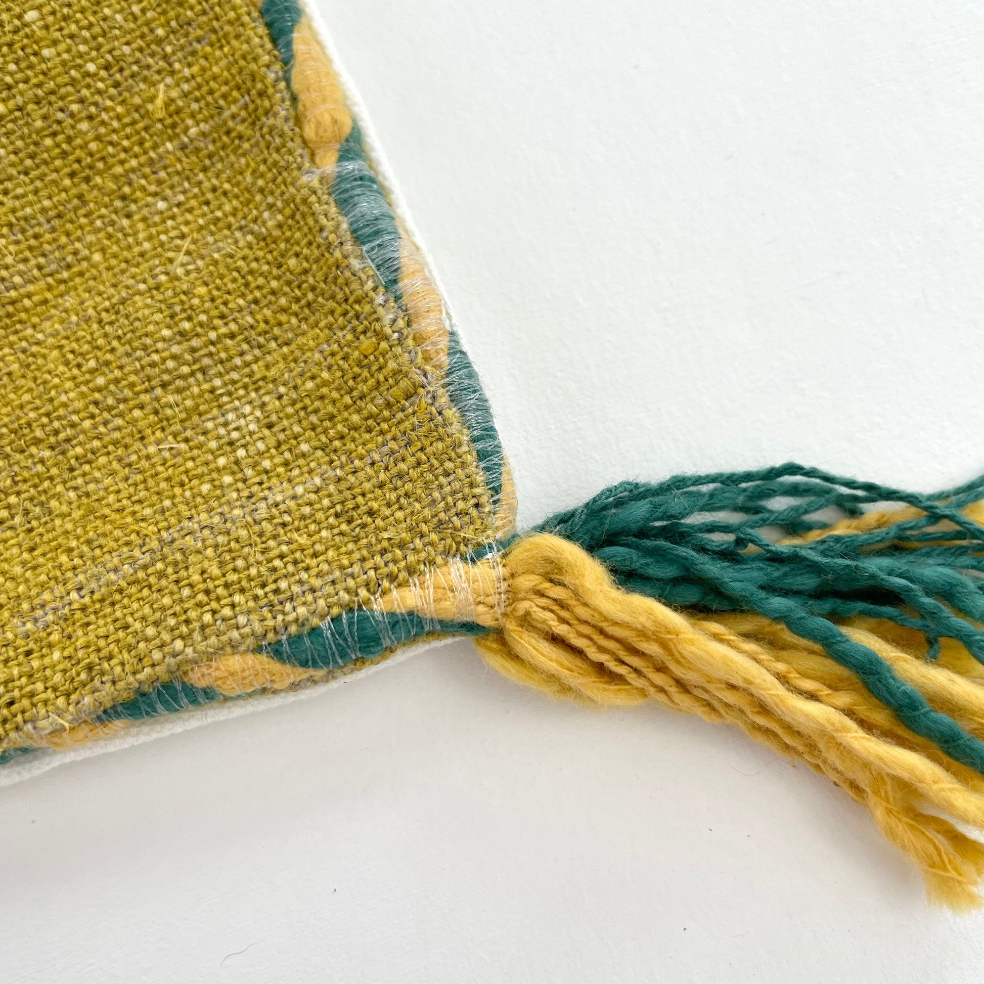 mustard yellow linen 18x18 square pillow cover with striped edging and tassels