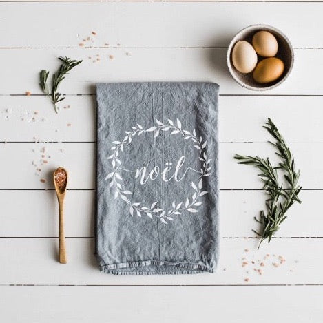 set of 2 grey 100 percent organic cotton hand printed Christmas holiday dishtowels for a farmhouse kitchen with noel printed on them in white ink