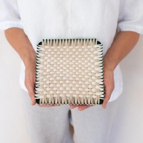 handmade 100 percent cotton geometric woven potholder or trivet on the loom for a farmhouse kitchen