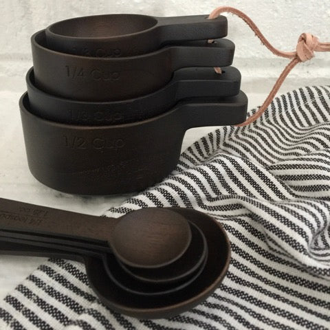 hand carved ebony teak wood measuring cup set paired with matching ebony teak wood measuring spoons set