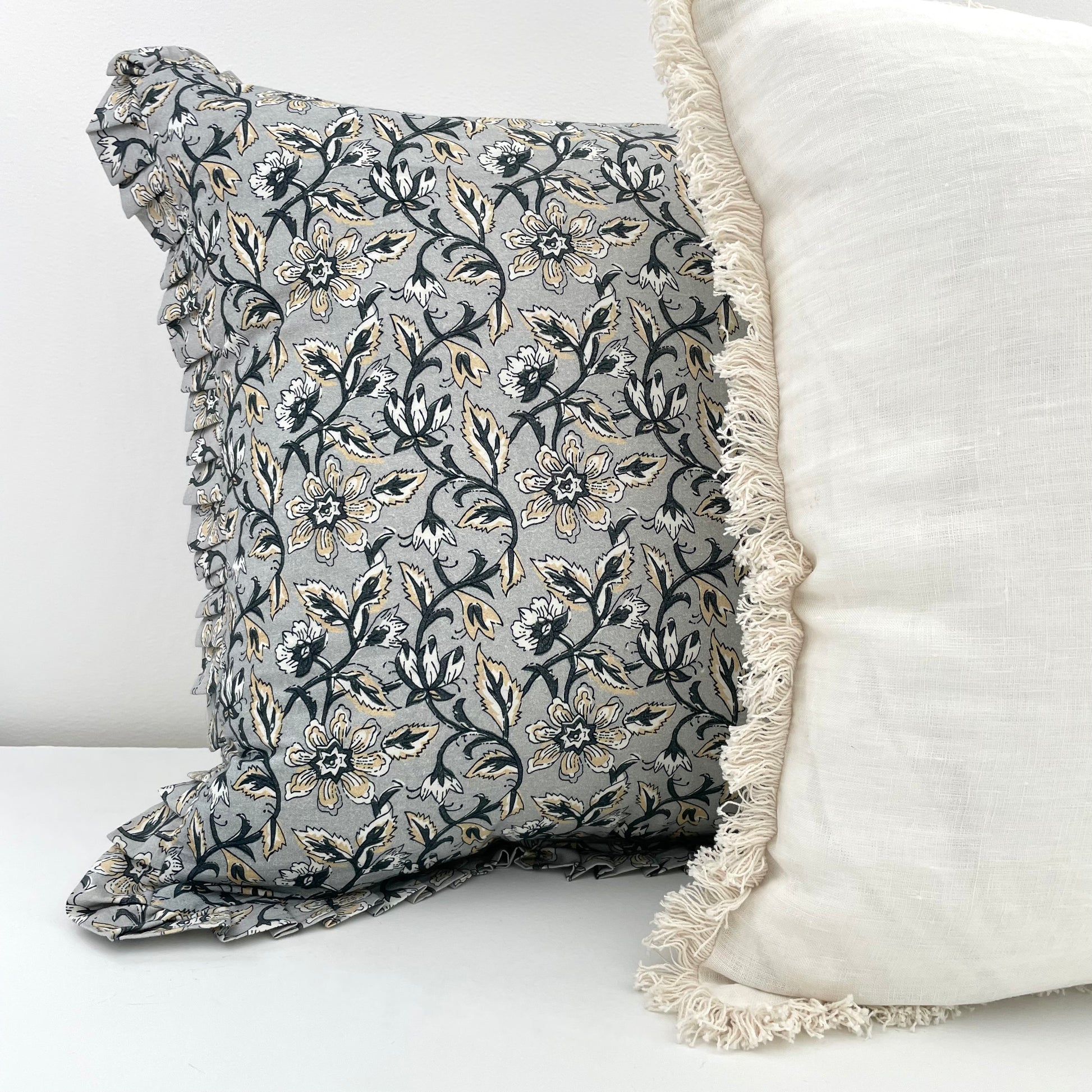 off white linen pillow cover and grey floral with ruffled edges