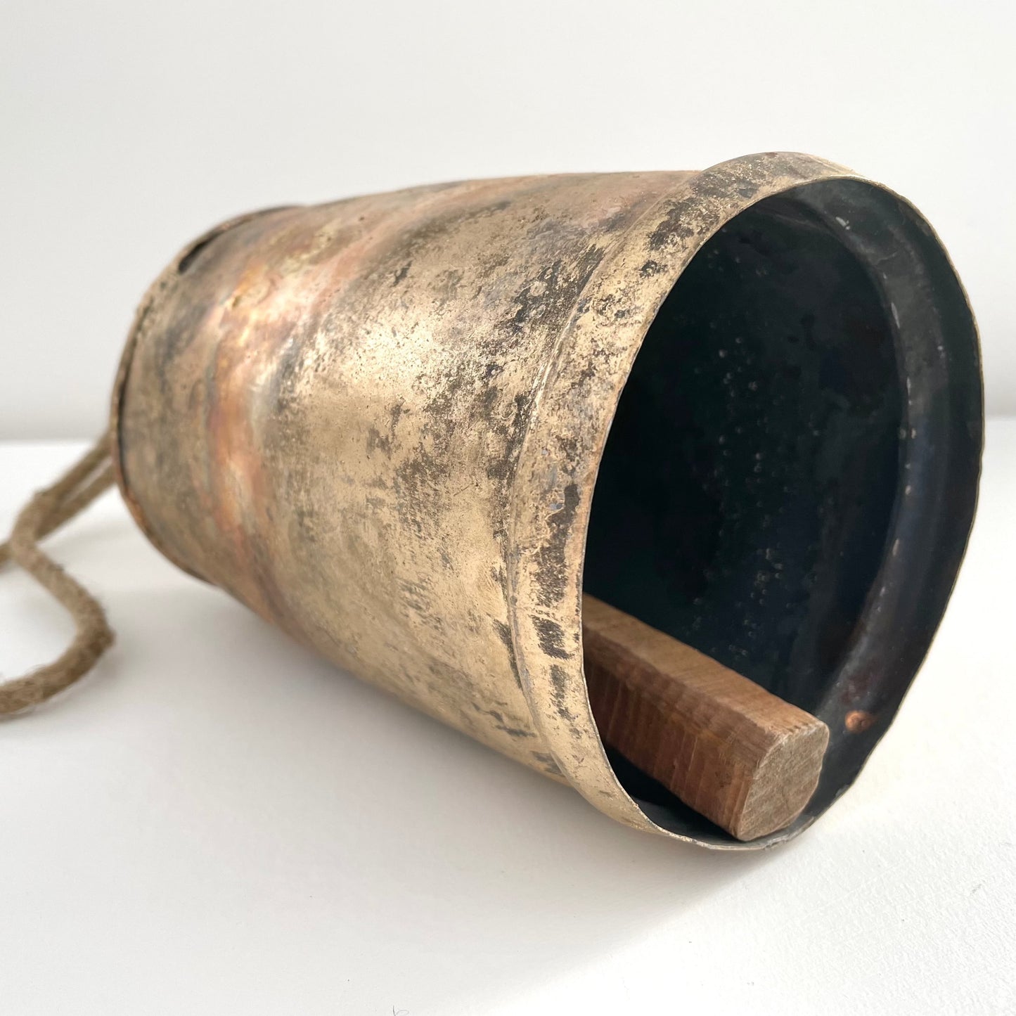 9 1/2" rustic tin bell with brass finish and wood striker