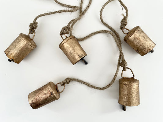 rustic brass finish cluster of 6 bells hanging on a jute string for holiday Christmas decor