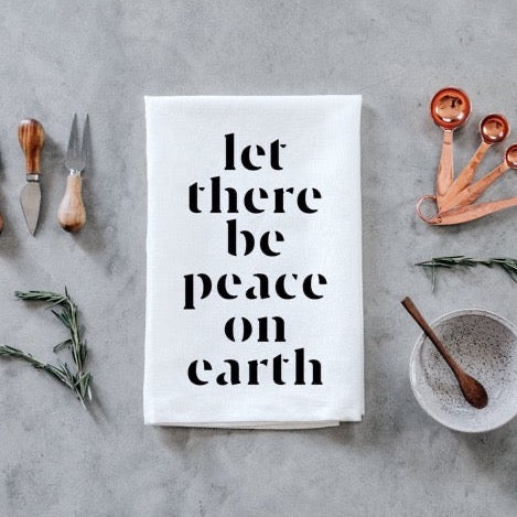set of 2 white 100 percent cotton hand printed Christmas holiday dishtowels for a farmhouse kitchen with let there be peace on earth printed on them in black ink