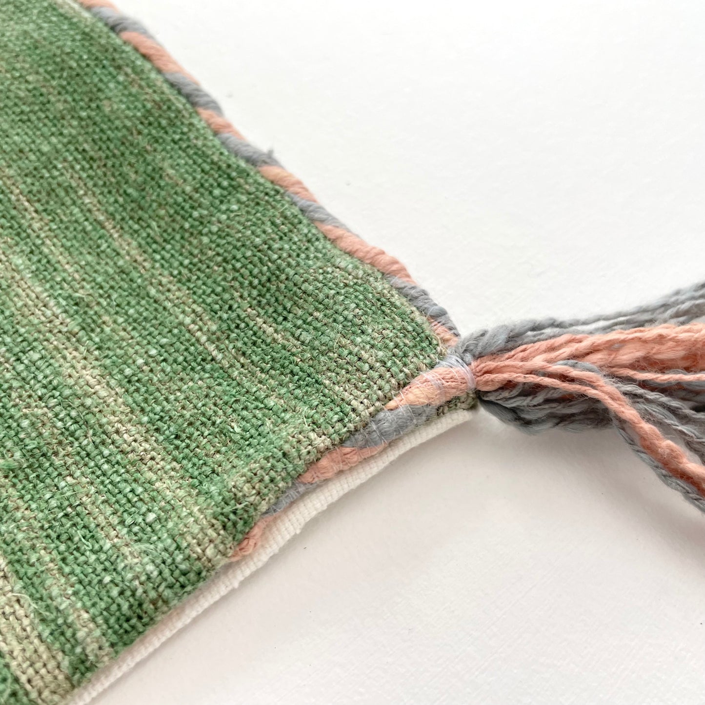 green linen 24x16 lumbar pillow cover with striped edging and tassels
