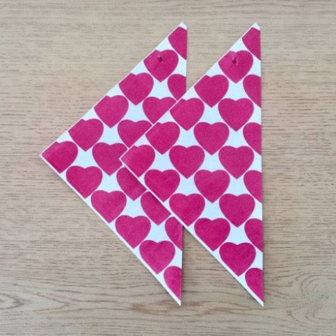 red and white heart printed paper party cones for popcorn and treats