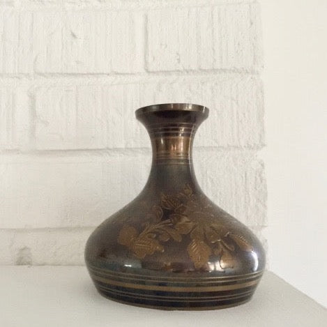 vintage brass vase with an etched floral and foliage pattern