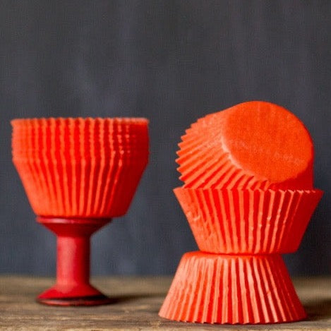 bright orange solid paper cupcake liners for circus party supplies