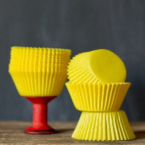 bright yellow solid paper cupcake liners for circus party supplies