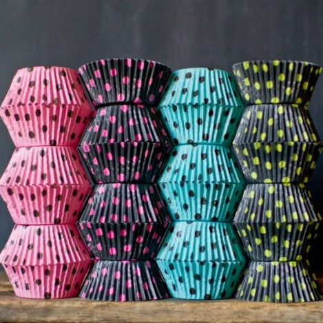 pink, turquoise, black, and neon green polka dot paper cupcake liners