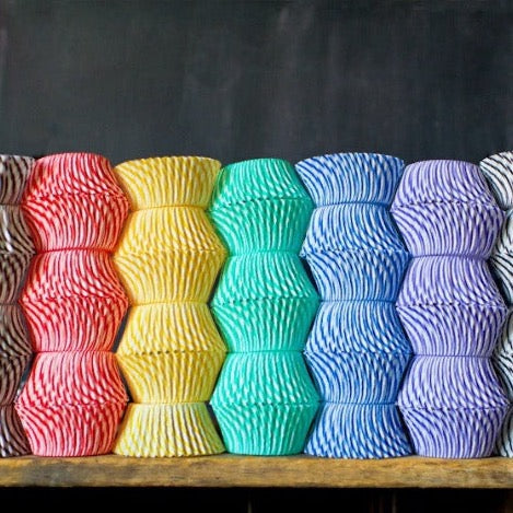 striped paper cupcake liners for circus party supplies in a rainbow of colors