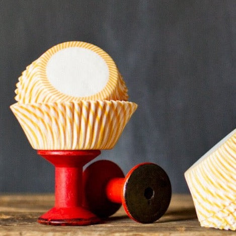 yellow and white striped paper cupcake liners for circus party supplies