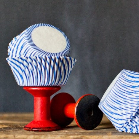 blue and white striped paper cupcake liners for circus party supplies