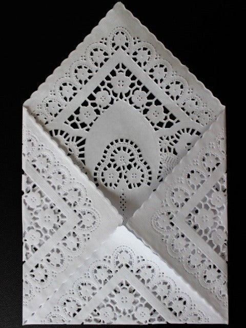 white square paper doilies to make wedding invitation envelopes