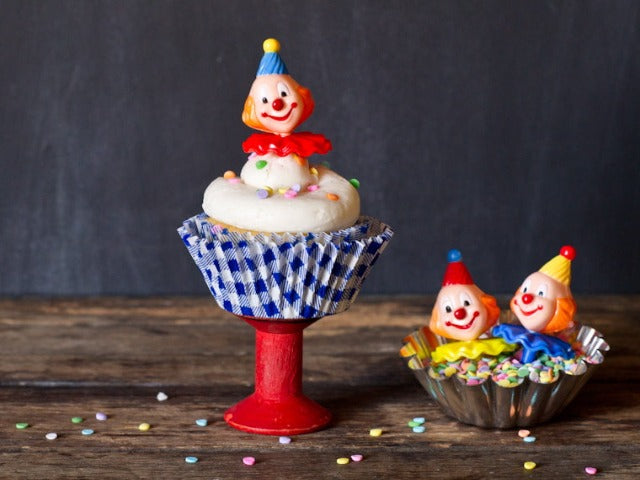 retro clown cupcake toppers for a birthday party in blue and white gingham cupcake liners