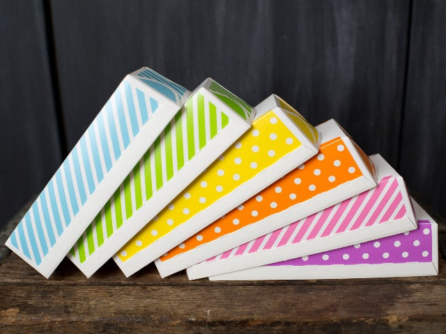 paper loaf baking pans in stripes and polka dots in a rainbow of colors