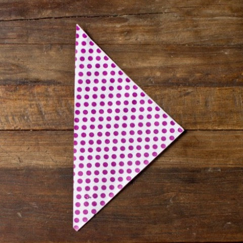 purple and white polka dot paper party cones to hold popcorn or treats
