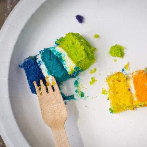 eco wooden fork with rainbow layered cake