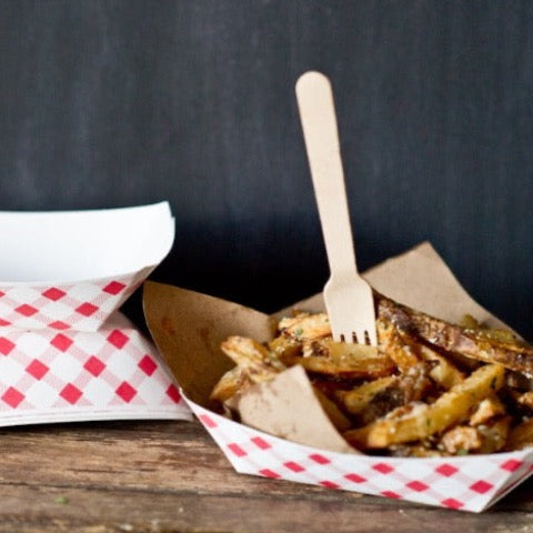 eco wooden fork in a red and white gingham paper boat of French fries 
