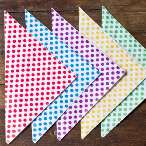polka dot paper party cones available in red, yellow, green, blue, and purple for party supplies