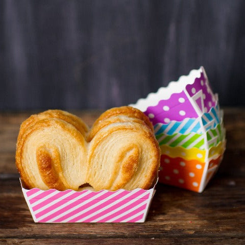 disposable striped and polka dot patterned paper disposable loaf baking pans in a rainbow of colors