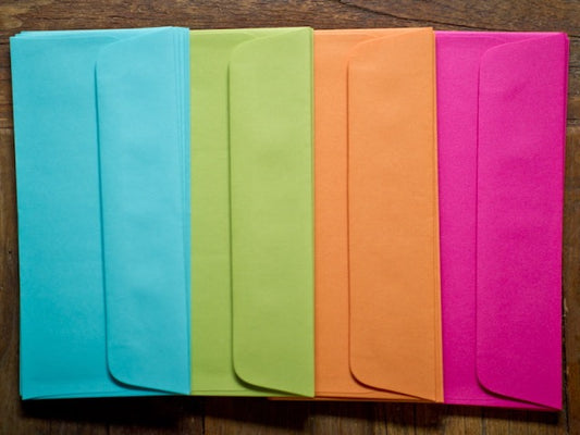 bright envelopes in solid turquoise, lime green, orange, and hot pink standard size for letter writing stationery