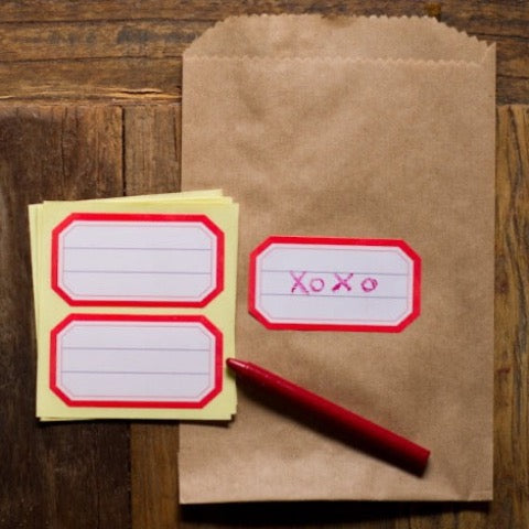 brown kraft paper candy, treat, and gift bags with red lined sticker labels on the front